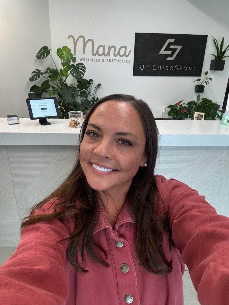Lani, founder of Mana Wellness and Aesthetics, at the front desk