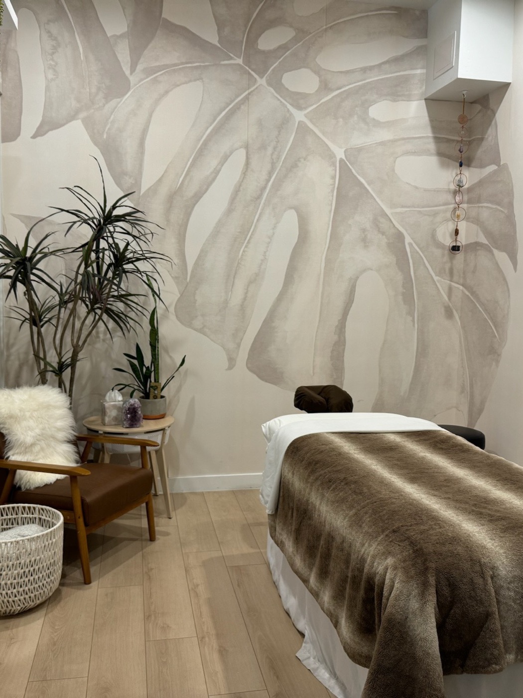 A serene massage treatment room at Mana Wellness