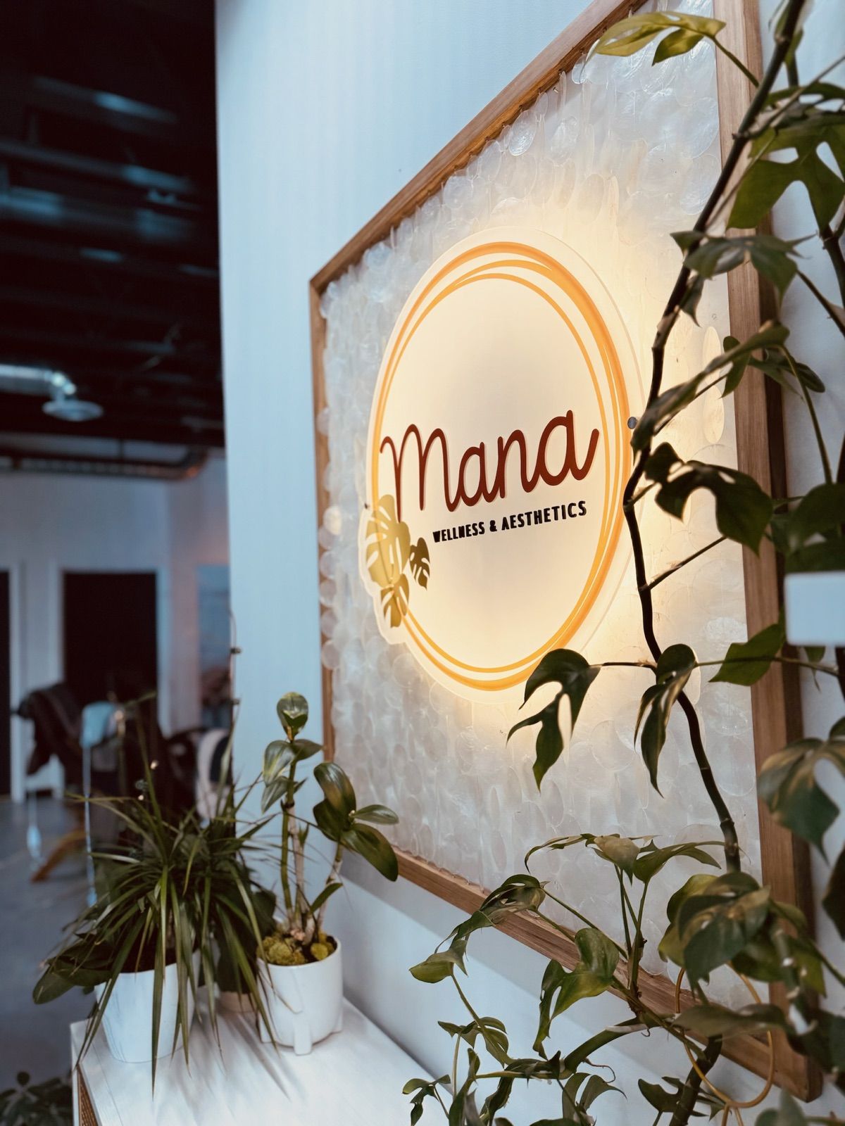 The gold Mana Wellness sign